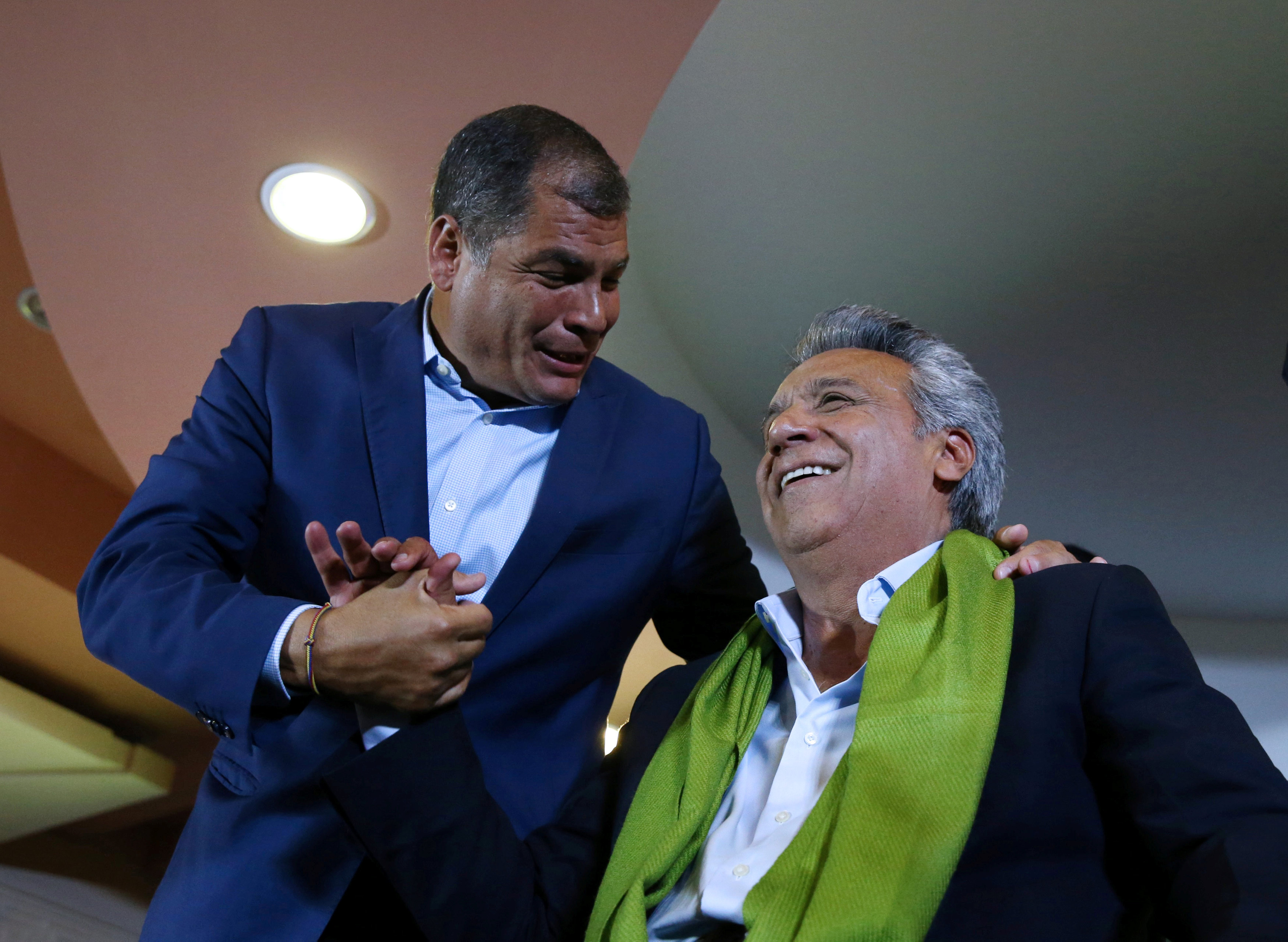 Ecuadorean presidential candidate Lenin Moreno is greated by Ecuador's President Rafael Correa while waiting for the results of the national election in a hotel, in Quito