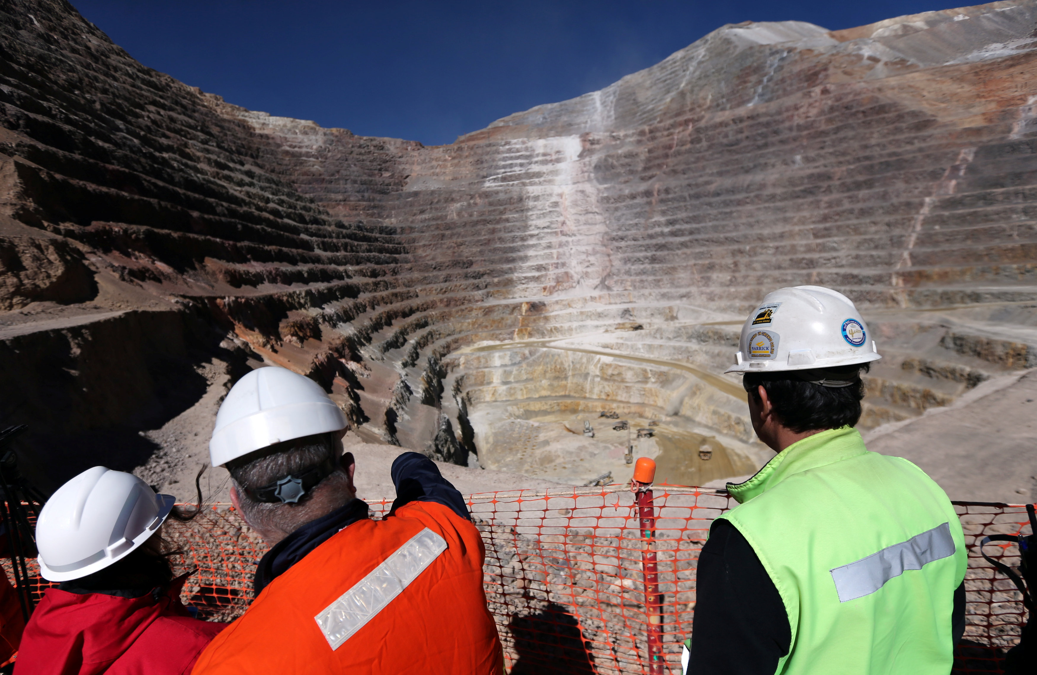 Workers stand next to an open pit at Barrick Gold Corp's Veladero gold mine in Argentina's San Juan province