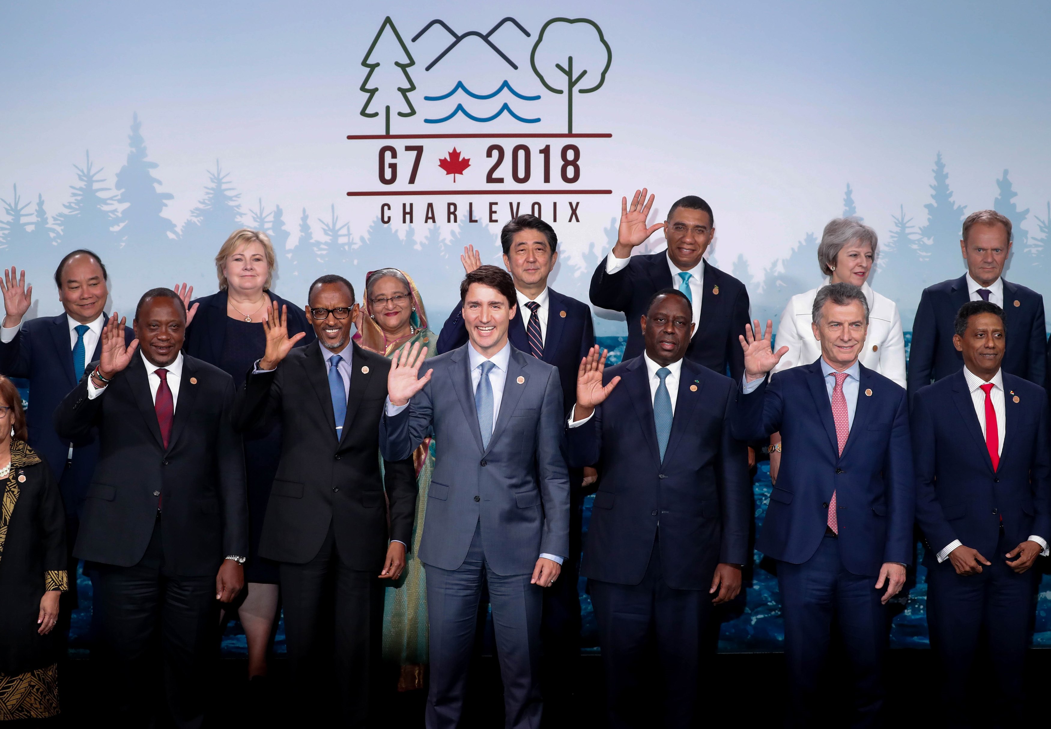 Leaders pose for group photo at a G7 and outreach countries meeting as part of a G7 summit in La Malbaie