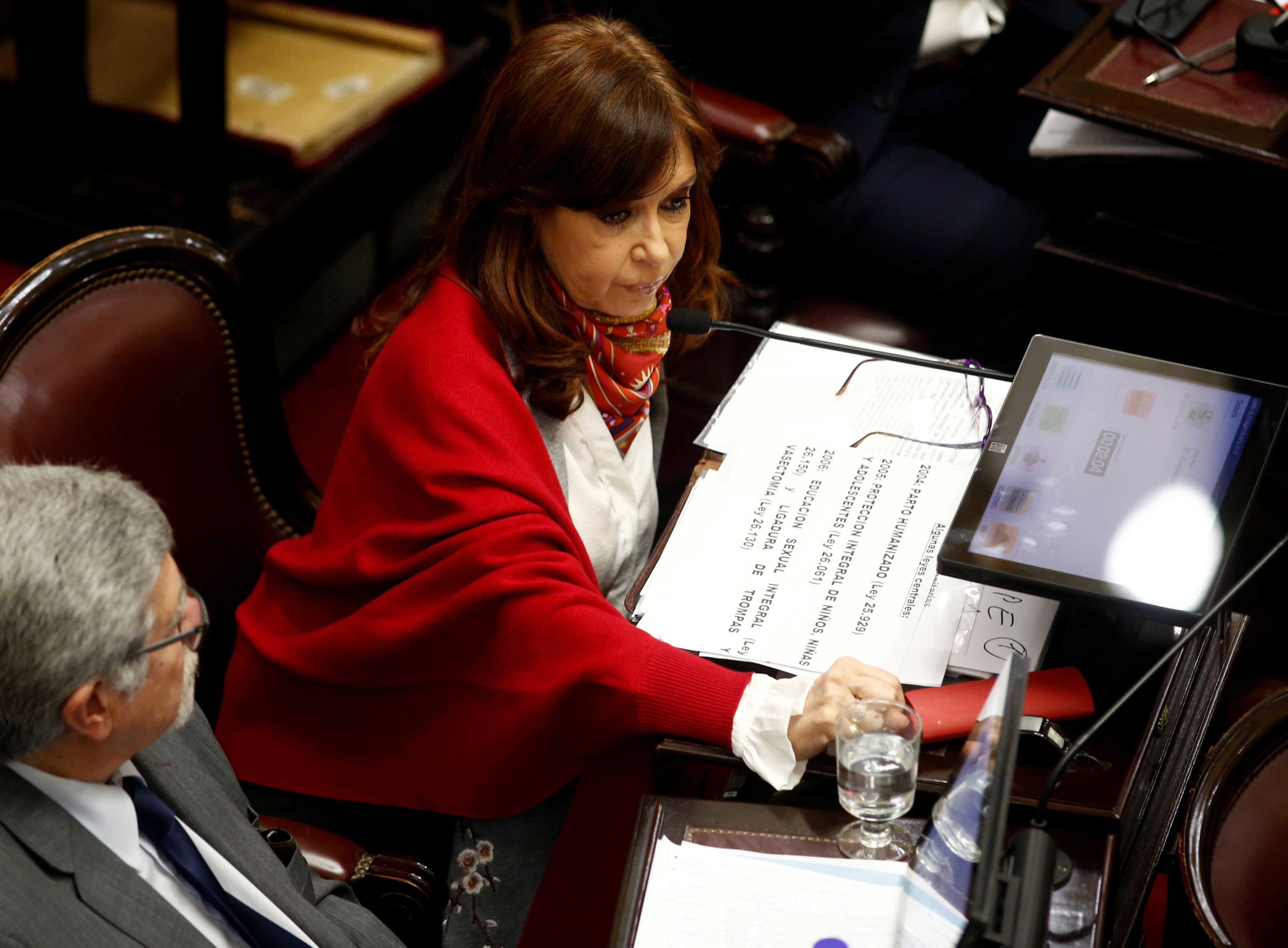 Senator and former Argentine President Cristina Fernandez de Kirchner sits next to Senator Marcelo Fuentes as lawmakers debate on a bill that would legalize abortion, in Buenos Aires Senator and former Argentine President Cristina Fernandez de Kirchner sits next to Senator Marcelo Fuentes as lawmakers debate on a bill that would legalize abortion, in Buenos Aires