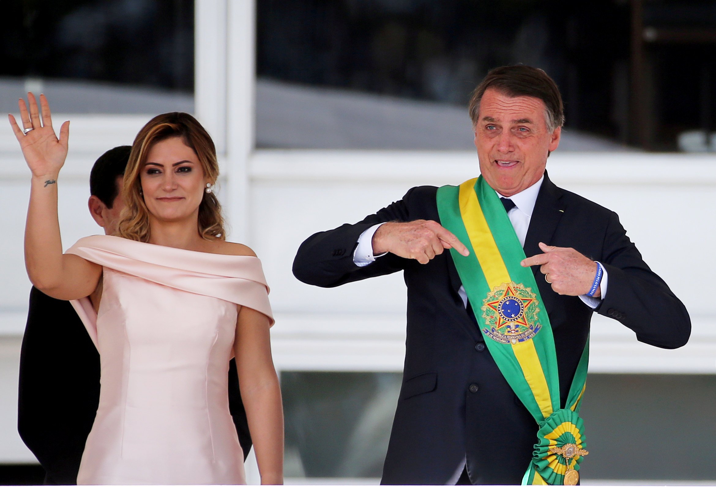 Brazil's new President Jair Bolsonaro gestures after receiving the presidential sash from outgoing President Michel Temer at the Planalto Palace, in Brasilia, Brazil January 1, 2019. REUTERS/Sergio Moraes TPX IMAGES OF THE DAY