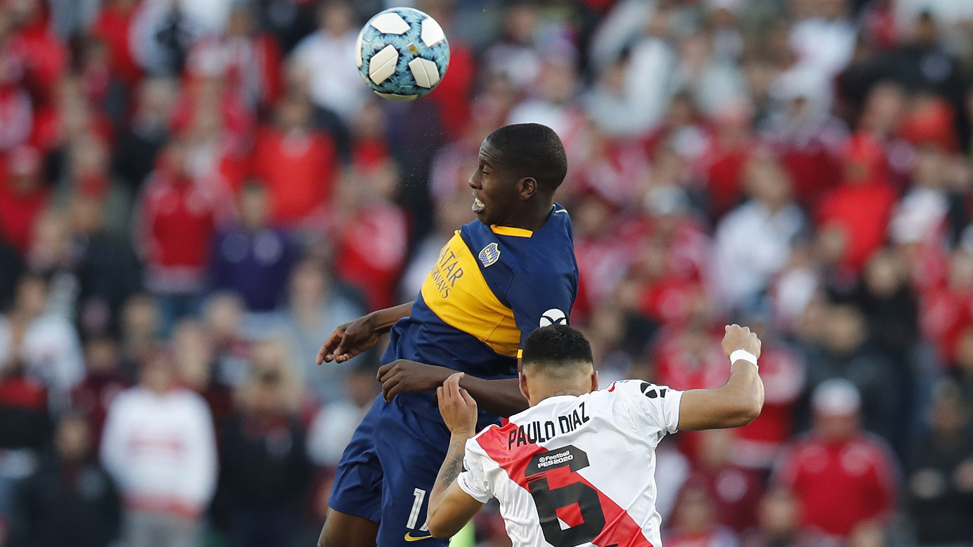 Boca Juniors' Jan Hurtado, top, heads the ball challenged by River Plate's Paulo Diaz during their Argentine first division soccer game in Buenos Aires, Argentina, Sunday, Sept. 1, 2019. (AP Photo/Natacha Pisarenko)